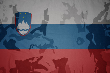 flag of slovenia on the khaki texture . military concept