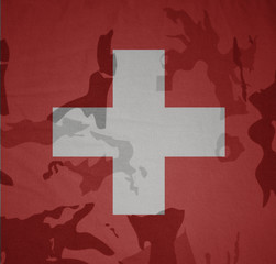 flag of switzerland on the khaki texture . military concept