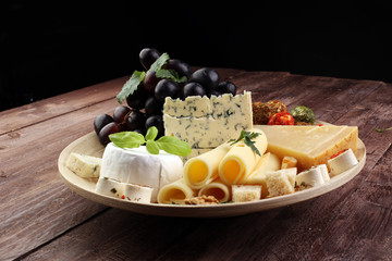 Cheese platter with different cheese and grapes