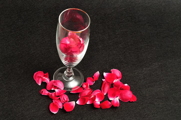 A champagne glass filled with rose petals