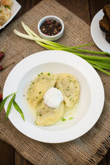 Dumplings with meat and greens. Wooden background. Top view. Close-up
