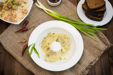 Dumplings with meat and greens. Wooden background. Top view. Close-up