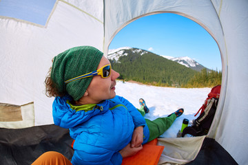 hiker resting in the tent in the Carpathians mountains at winter