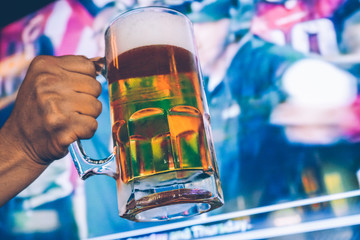 Draft Beer with a tv screen sports background - 136113866