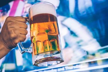 Draft Beer with a tv screen sports background - 136113875
