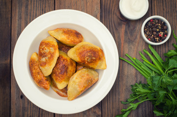Fried dumplings. Wooden background. Top view