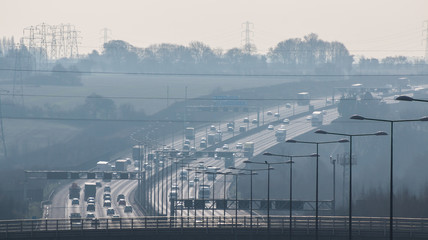 British motorway in a rush hours, in a foggy afternoon