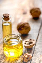 cosmetic and therapeutic walnut oil on wooden background