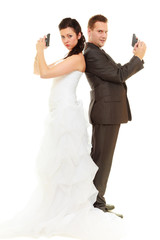 Groom and bride in wedding outfit holding guns