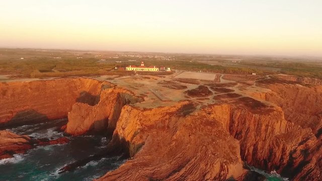 Lighthouse on the beautiful cliff at sunset in Portugal