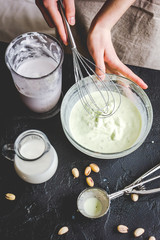 organic ice cream homemade process on dark background with hands