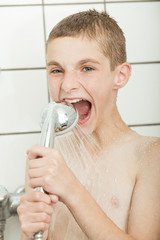 Boy biting shower headset