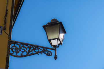 Fototapeta na wymiar External electrical lanterns with blue sky as background. Brescello 18/04/2016