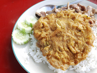 Close up of Fried pork with garlic and pepper on rice with omelette, Thai food style