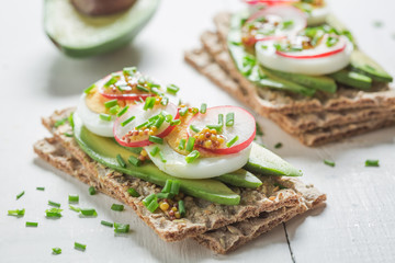 Fresh sandwich with avocado, eggs and radish