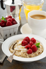 Steel cut oatmeal porridge with raspberry and coconut