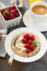 Steel cut oatmeal porridge with raspberry and coconut