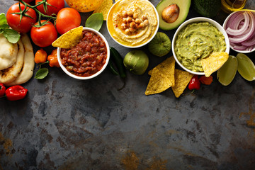 Homemade hummus, salsa and guacamole with corn chips
