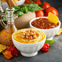 Homemade hummus and tomato salsa in white bowls