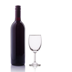 Bottle of red wine and glass. Studio shot isolated on white
