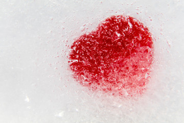 Red heart frozen in ice on side Valentine's Day background