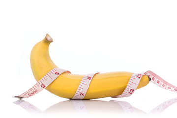 Yellow banana with measurement tape. Men penis size concept..Stu