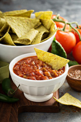 Red tomato spicy salsa with chips