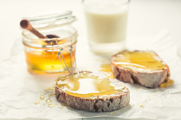 Healthy sandwich with honey for breakfast with milk