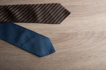 Silk neck ties on wooden background.
