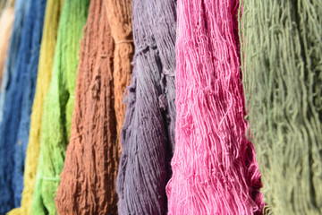 The raw organic cotton yarn in tray with the colorful thread.The yellow organic handmade cotton