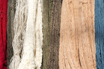 The raw organic cotton yarn in tray with the colorful thread.The yellow organic handmade cotton