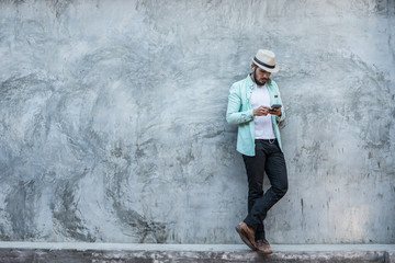 Portrait of handsome young hipster man listening to music.