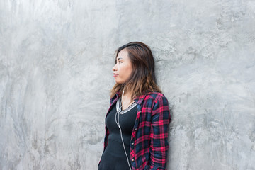 Portrait of handsome young hipster woman listening music.
