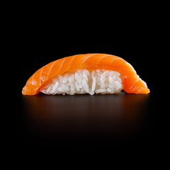 traditional fresh japanese sushi rolls on a black background