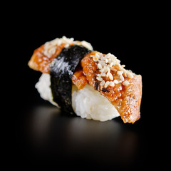 traditional fresh japanese sushi rolls on a black background