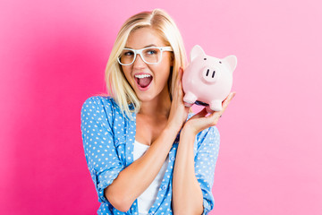 Young woman with a piggy bank