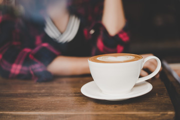 Hipster woman sitting at cafe.
