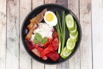 Jasmine rice with meat and boiled egg topped red sweet sauce .