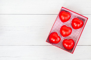 Top view red heart and gift box with ribbon on white wooden plan