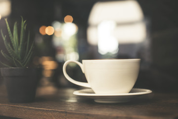Vintage tone of hot coffee latte art in cup on table.