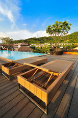 Rattan sunbeds at the poolside