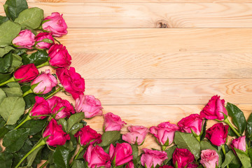 Fototapeta na wymiar Fresh pink rose flower on wooden deck. For love or valentine day