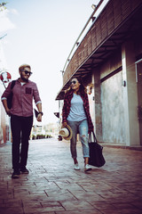 Portrait of hipster couple walking in the street urban.