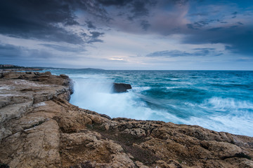 Waves crasching at cliffs at Mediterranean Sea in Spain