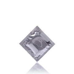 Condom in silver pack. Studio shot isolated on white