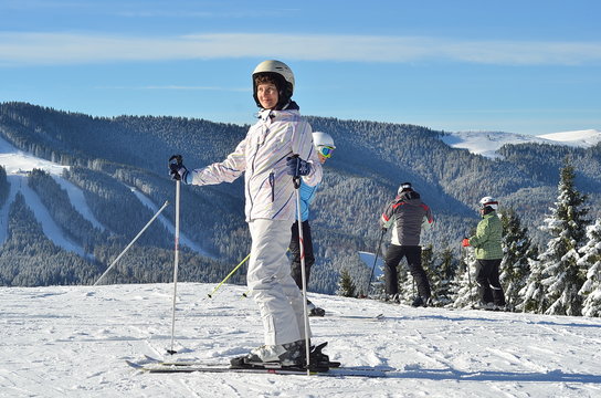 Ski, skier woman enjoying winter vacation, mountain background