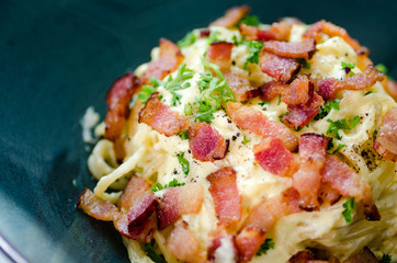 Close-up of classical spaghetti carbonara in clay bowl