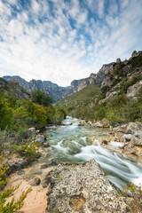 Fototapeta na wymiar Fast flowing creek in Els Ports Natural Park, Spain