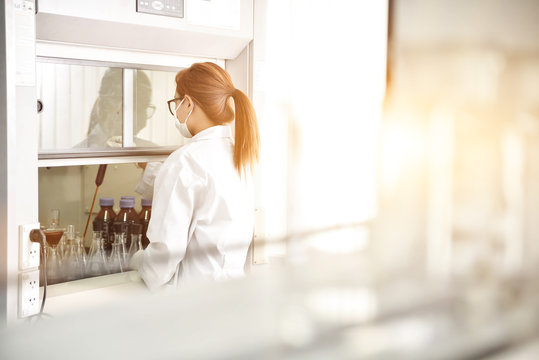 Young laboratory assistant prepare instrument for chemical lab e