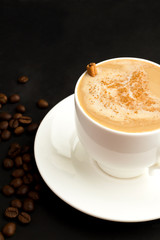 cappuccino with cinnamon on a dark background